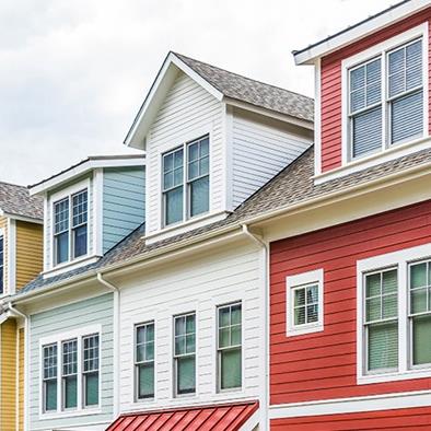 row of colorful red yellow blue white green painted townhouses